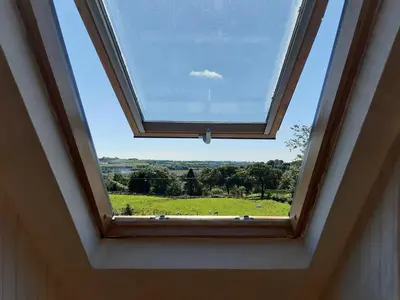 a window in a room with a view of a field at Old Barn Farmhouse - Cc in Uplawmoor