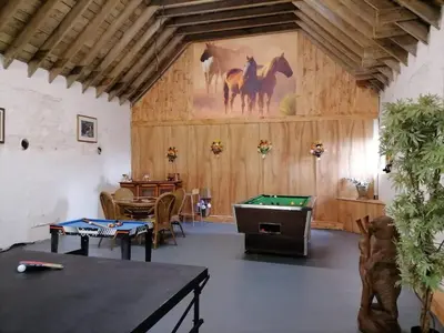 a room with a pool table and a painting of horses at Old Barn Farm Cottage - Cc in Uplawmoor
