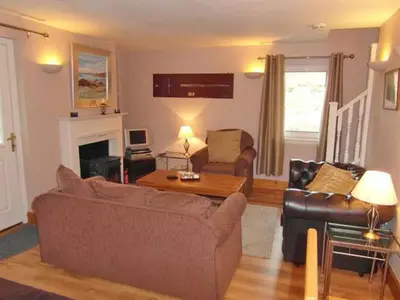 a living room with a couch and a table at Bramble Cottage 1, 2 & 3 in Lochdon
