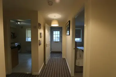 a hallway with a hallway leading to a room at Dunfermline - Premium Two Bedroom Apartment - KW in Dunfermline
