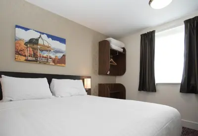 a bedroom with a large white bed and a window at Sweet Chestnut, Dunfermline by Marston's Inns in Dunfermline
