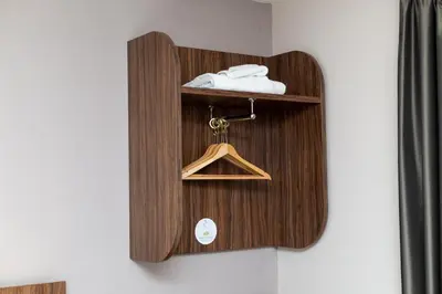 a wooden shelf with a hanger on a wall at Sweet Chestnut, Dunfermline by Marston's Inns in Dunfermline
