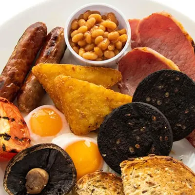 a plate of food with eggs sausage bread and beans at Sweet Chestnut, Dunfermline by Marston's Inns in Dunfermline