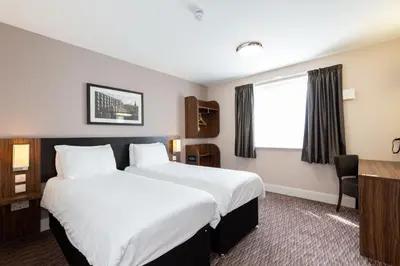 a hotel room with a large bed and a desk at Sweet Chestnut, Dunfermline by Marston's Inns in Dunfermline