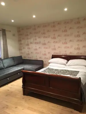 a bedroom with a bed and a couch at Lanark Residence in Edinburgh