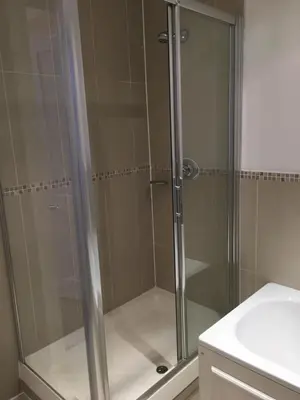 a shower with a glass door in a bathroom at Lanark Residence in Edinburgh