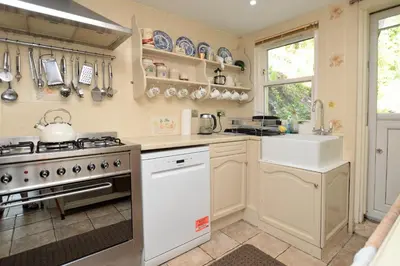 a kitchen with a stove and a sink at Ardmun House in Dunoon