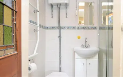 a bathroom with a sink and a shower at Ardmun House in Dunoon