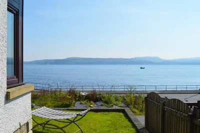 a patio with a view of the water at Clydeside Villa in Dunoon