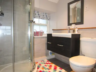 a bathroom with a toilet and a sink and a shower at Newton Cottage South in Inveraray
