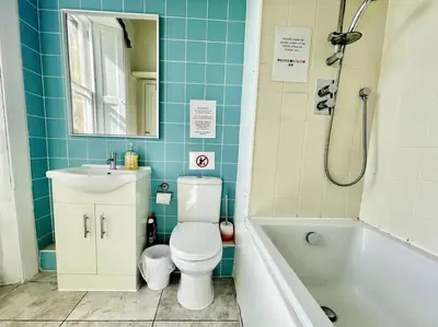 a bathroom with a toilet and a sink and a tub at Lauriston Park in Edinburgh