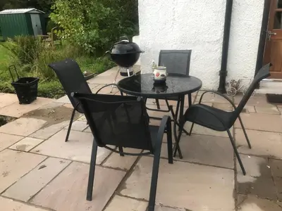 a black table and chairs on a patio at Garden Cottage in Gartocharn