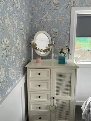 a bedroom with a white dresser and a mirror at Garden Cottage in Gartocharn