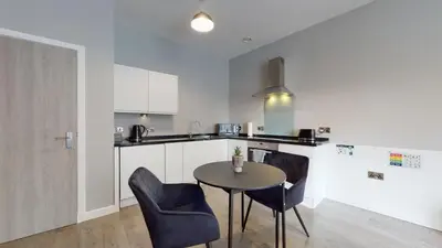 a kitchen with a table and chairs in a room at Glassford Residence in Glasgow