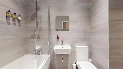 a bathroom with a toilet and a sink and a shower at Glassford Residence in Glasgow