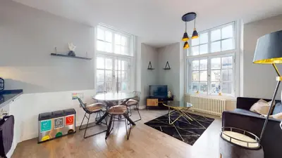 a living room with a couch and a table at Glassford Residence in Glasgow