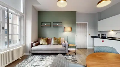a living room with a couch and a table at Glassford Residence in Glasgow