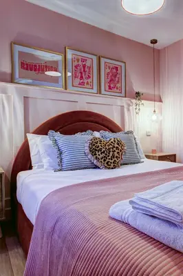 a bedroom with a large bed with purple walls at No5 Ayr Beach - Coorie Doon Stays in Ayr
