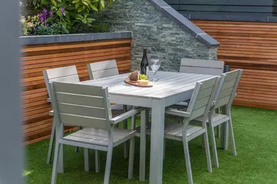 a white table and chairs with a bottle of wine at Garden Rooms Edinburgh in Edinburgh