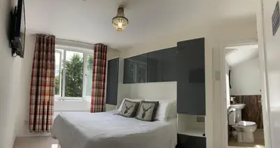a bedroom with a bed and a window at Norwood Guesthouse-Loch Lomond in Balloch