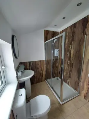 a bathroom with a shower and a toilet and a sink at Norwood Guesthouse-Loch Lomond in Balloch