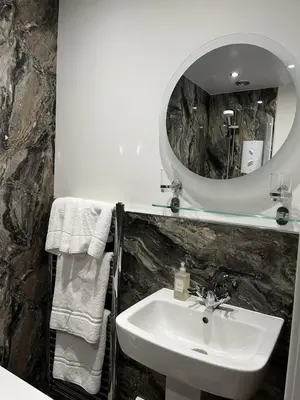 a bathroom with a sink and a mirror at Norwood Guesthouse-Loch Lomond in Balloch