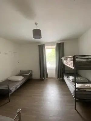 a room with three bunk beds and a window at Edinburgh West Side Hostel in Edinburgh
