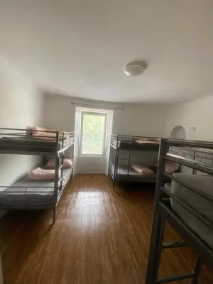 a room with four bunk beds and a window at Edinburgh West Side Hostel in Edinburgh