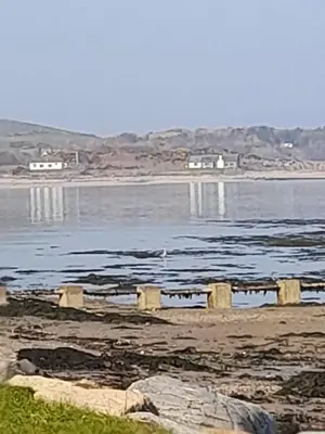 a large body of water with houses in the background at Fonn Na Mara in Campbeltown