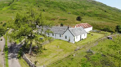 an aerial view of a house on a hill at Garrison Farm with Hot Tub in Inversnaid