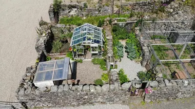 an overhead view of a glass house with plants at Garrison Farm with Hot Tub in Inversnaid