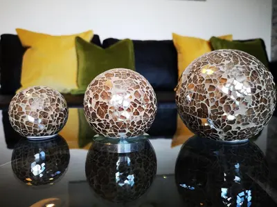 two glass balls on a table with a couch at Mycosy 605 in Paisley