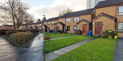 a row of brick houses on a residential street at Mycosy 605 in Paisley