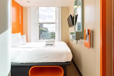 a small room with a bed and a window at easyHotel Edinburgh in Edinburgh