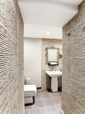 a bathroom with a sink and a toilet and a mirror at Barony Castle Hotel in Peebles