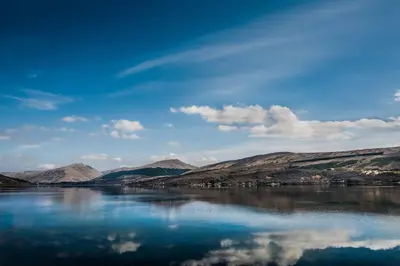 a view of a river with mountains in the background at Loch Fyne Hotel & Spa in Inveraray