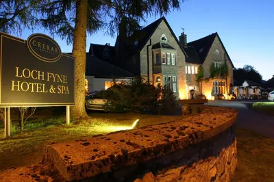a hotel sign in front of a house at Loch Fyne Hotel & Spa in Inveraray