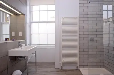 a bathroom with a sink and a shower at Destiny Scotland - Distillers House in Edinburgh