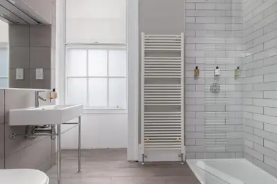 a bathroom with a shower and a sink and a tub at Destiny Scotland - Distillers House in Edinburgh