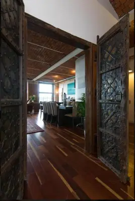 an open door into a dining room with a table at Loft Apartment in Port Glasgow