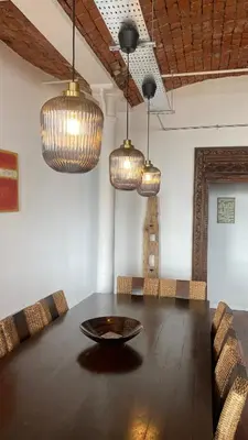 a large room with a table and chandeliers at Loft Apartment in Port Glasgow
