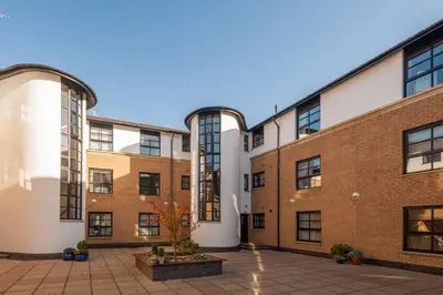 an apartment building with a courtyard at Glasgow City Flats - Merchant City in Glasgow