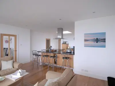a living room with a couch and a bar in it at Island View in Dunure