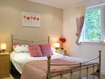 a bedroom with a bed and a window at Lia Fail in Ballachulish