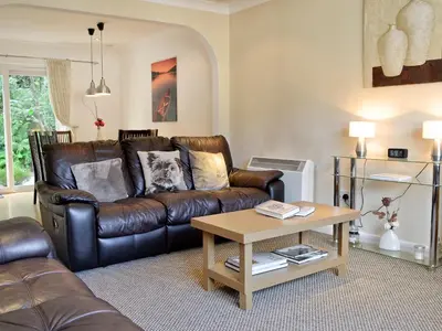 a living room with a leather couch and a coffee table at Lia Fail in Ballachulish