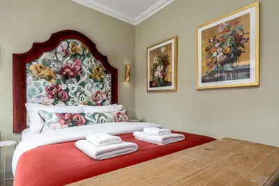 a bedroom with a large bed with towels on it at Munro Guest House in Stirling