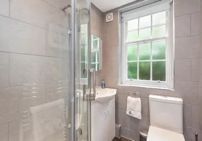 a bathroom with a shower and a toilet and a sink at Castle Suite 1 Old Town in Edinburgh