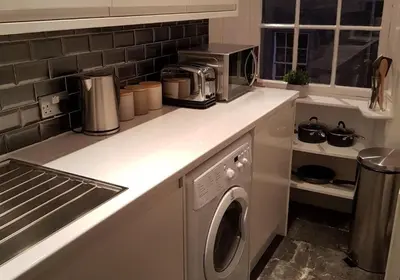 a kitchen with a washing machine on a counter at Thistle Suite city centre in Edinburgh