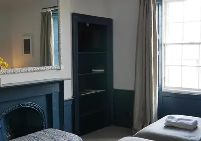 a living room with a fireplace and a mirror at Thistle Suite city centre in Edinburgh