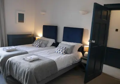 a bedroom with two beds with blue headboards at Thistle Suite city centre in Edinburgh